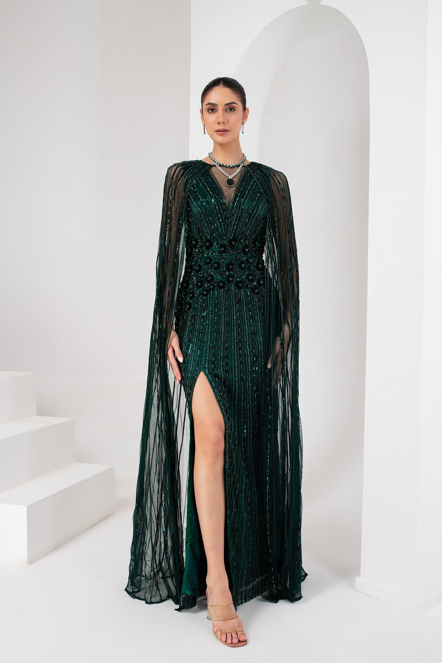 Midnight green heavily embellished gown with cape