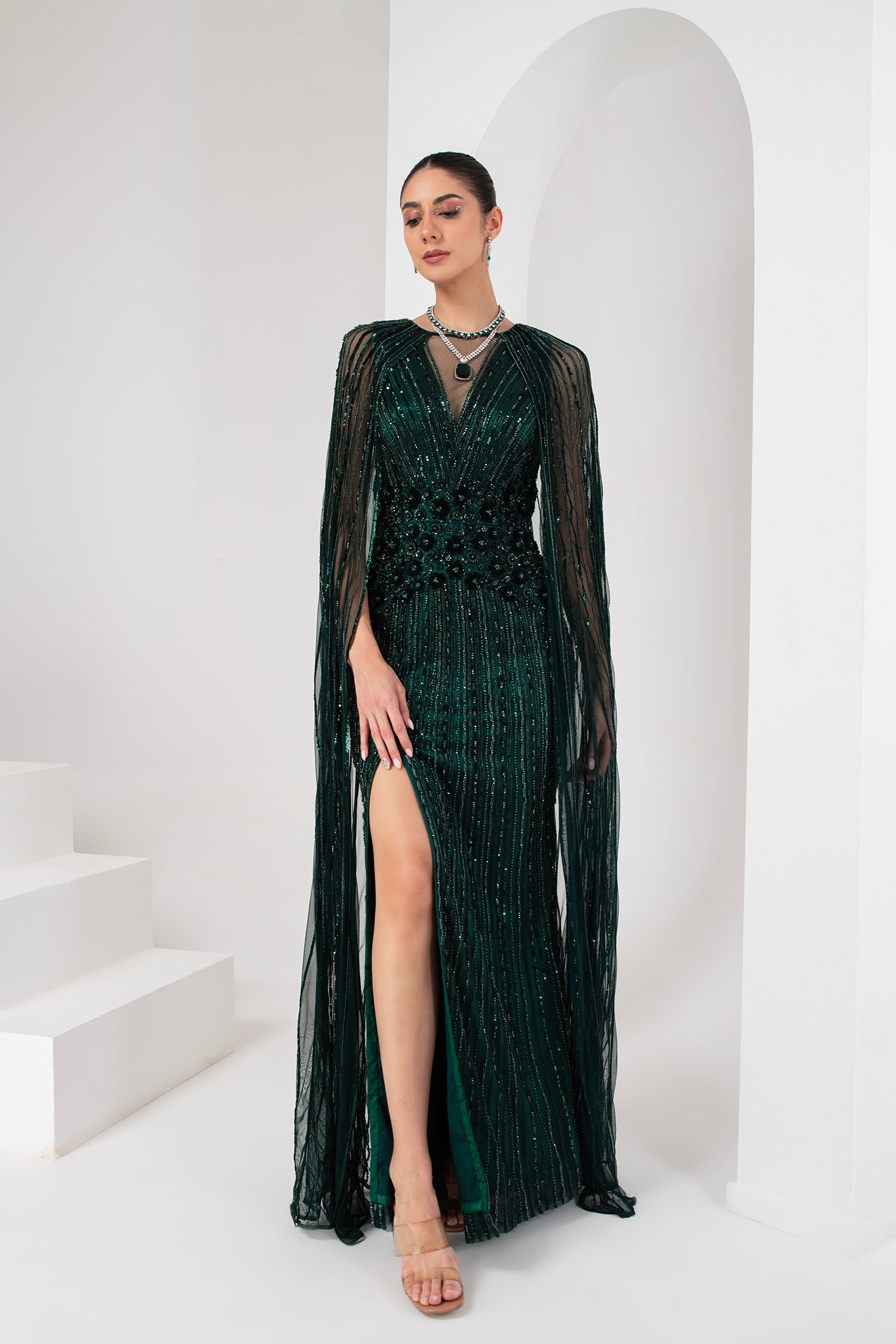 Midnight green heavily embellished gown with cape
