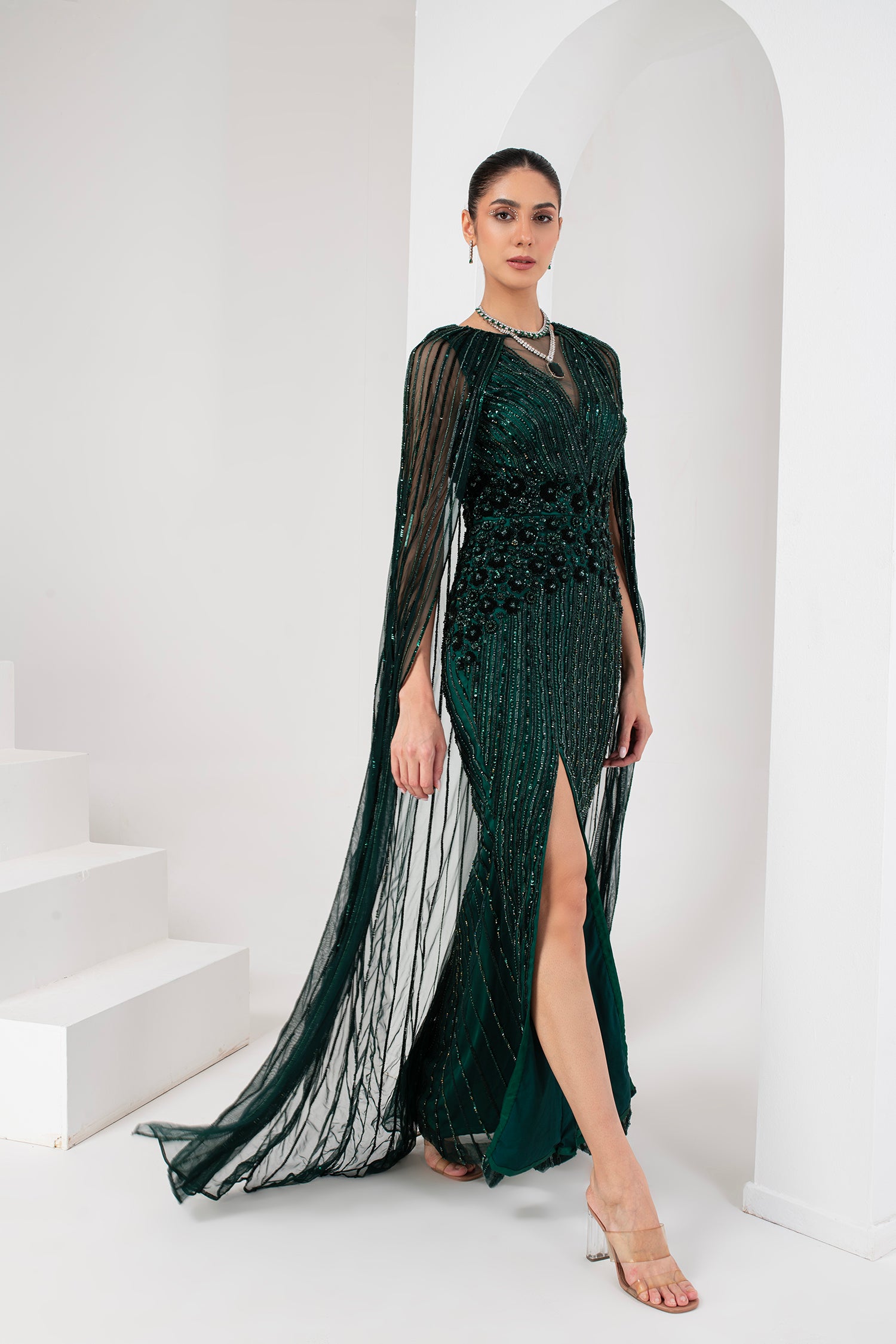 Midnight green heavily embellished gown with cape