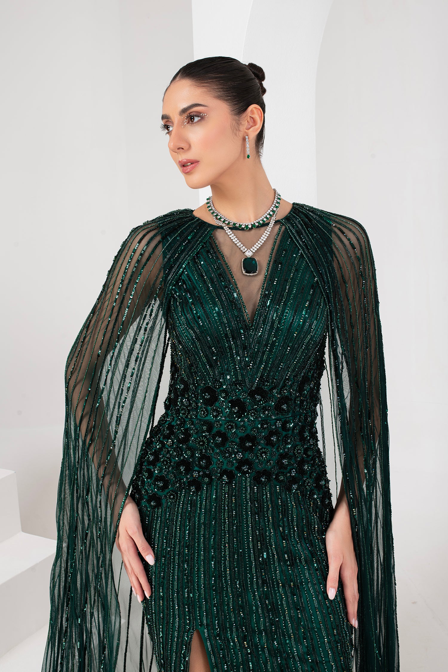 Midnight green heavily embellished gown with cape