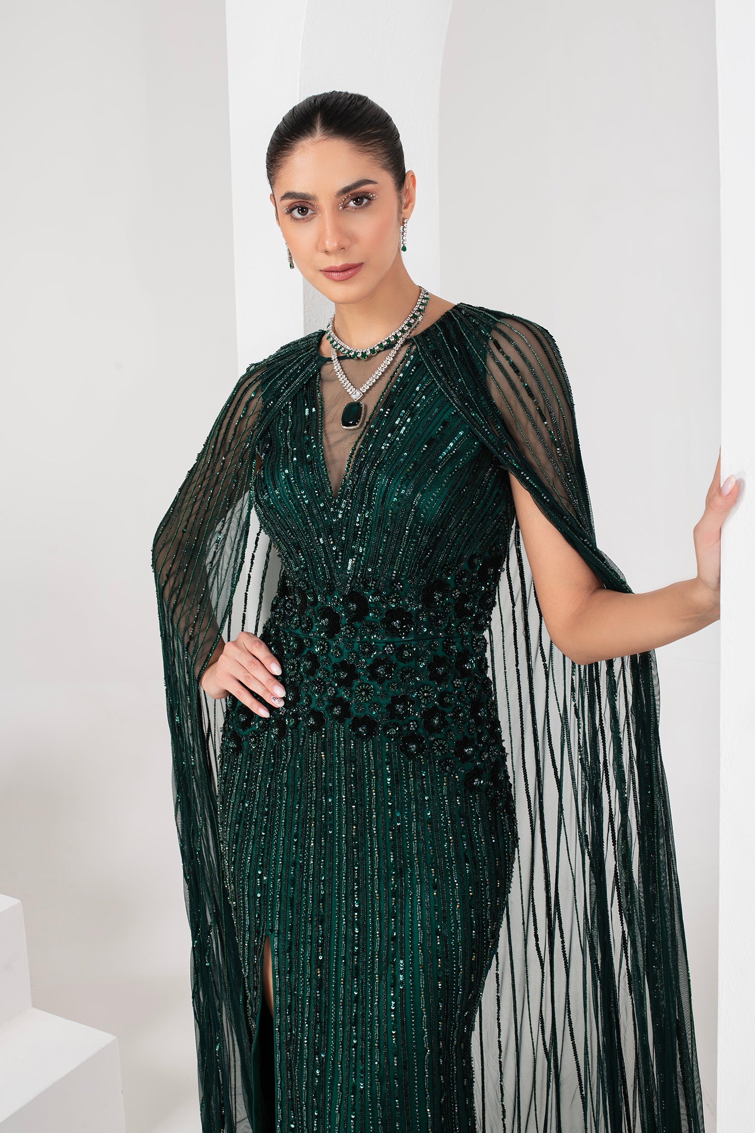 Midnight green heavily embellished gown with cape