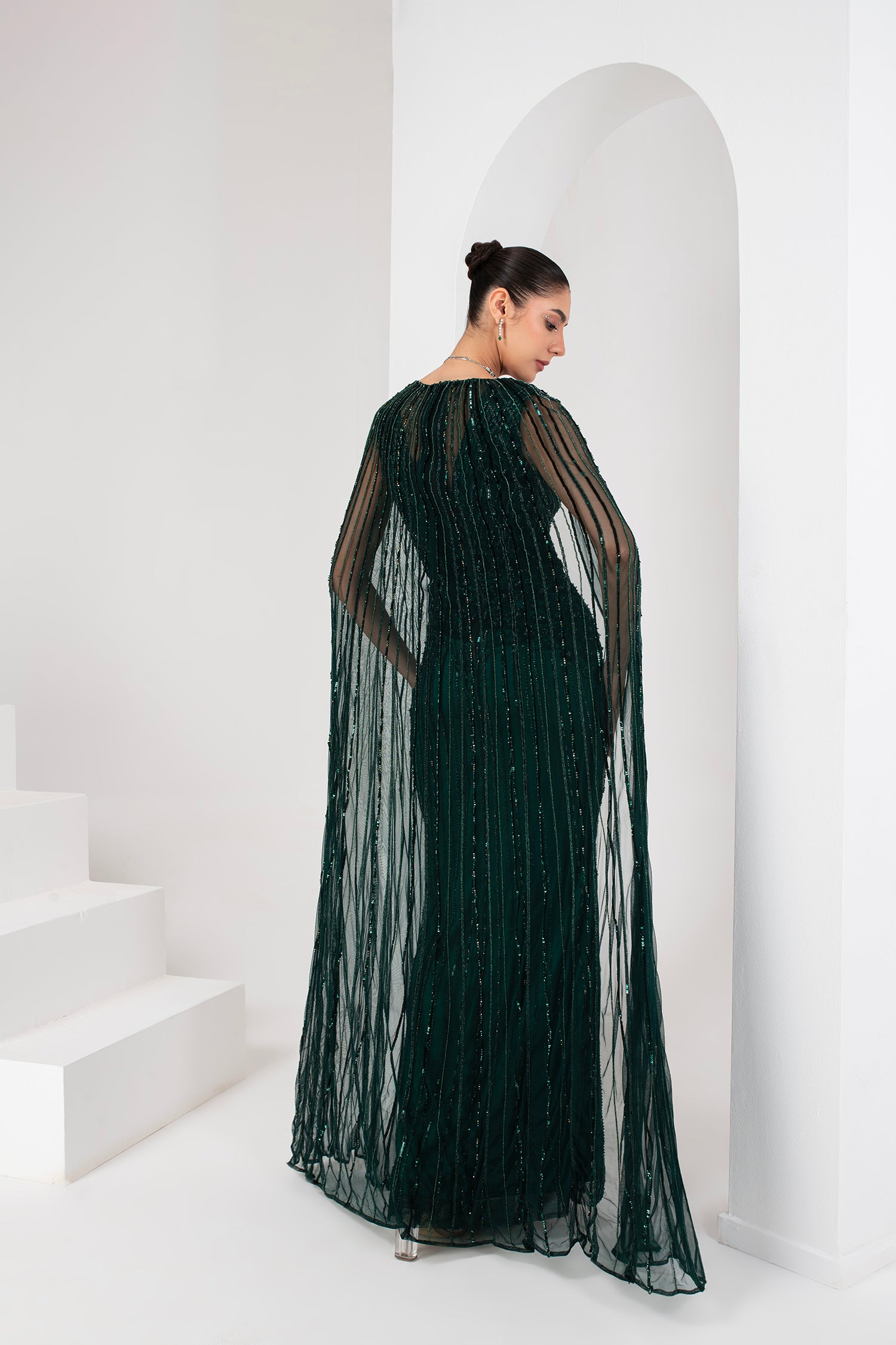 Midnight green heavily embellished gown with cape