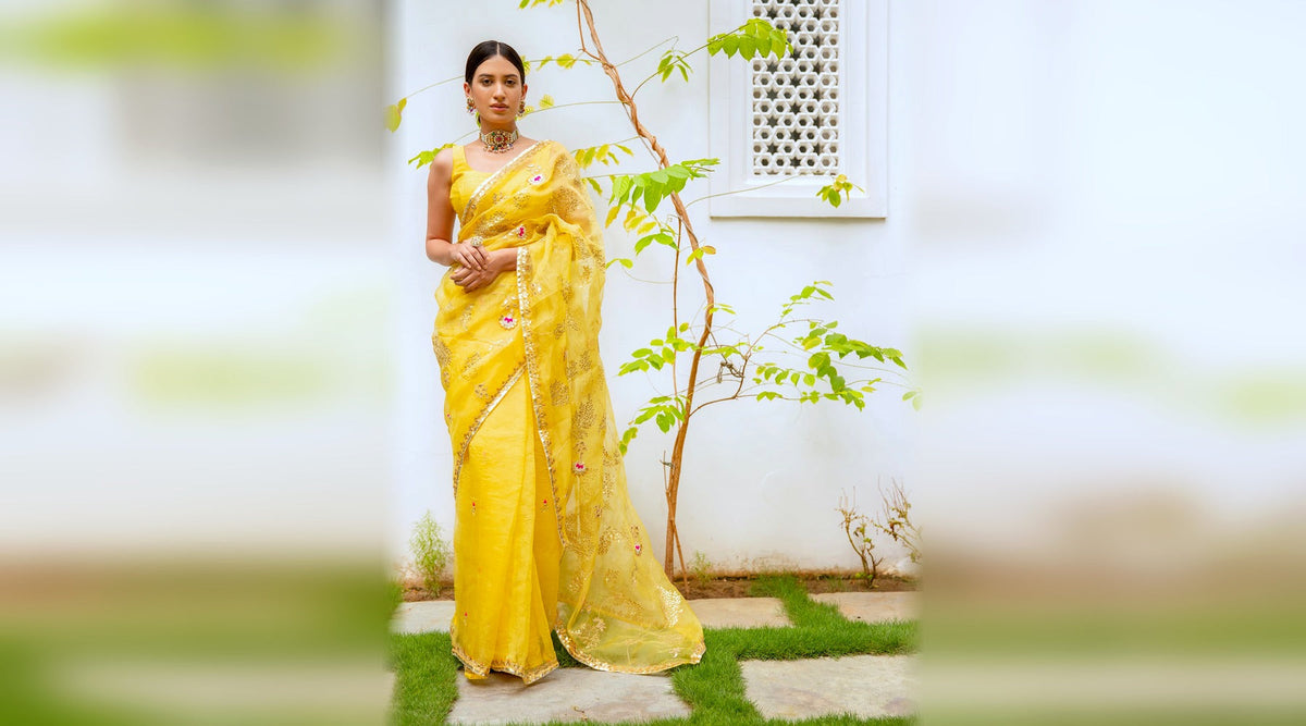 Yellow hand embroidered gota patti jaal saree worn for a haldi ceremony