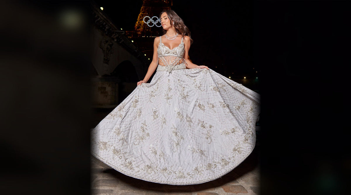 Ice grey habutai silk lehenga with hand embroidery, crystal jaal and sheer V-panel corset blouse, worn at night in Paris — Jigar and Nikita