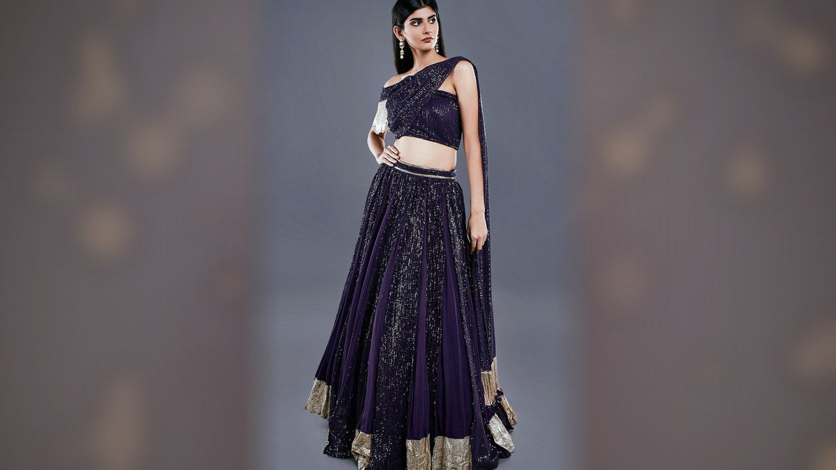 Purple sequin box-pleated sangeet lehenga with off-shoulder draped blouse and attached pallu, full outfit head-to-hem